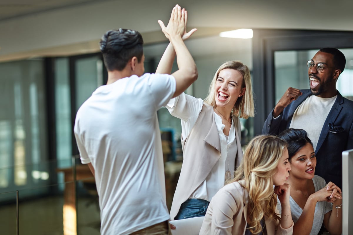 Small business team celebrating success at office