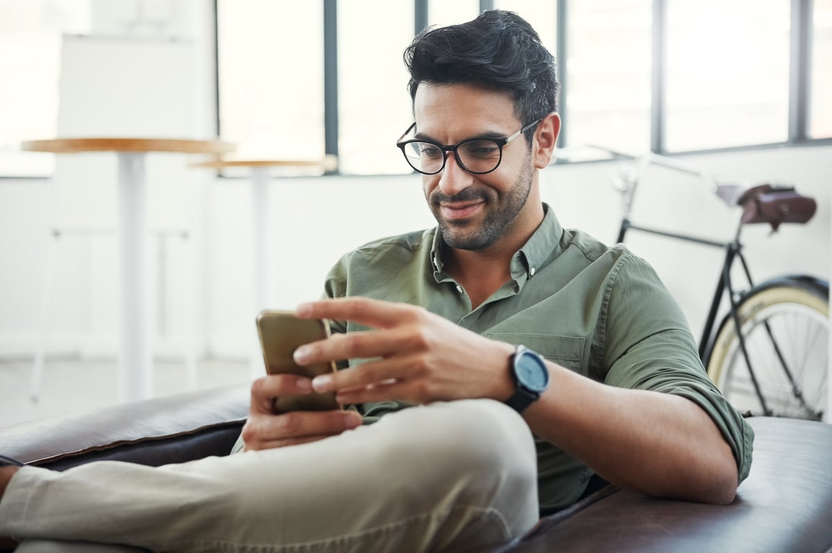 Happy business owner on phone at work